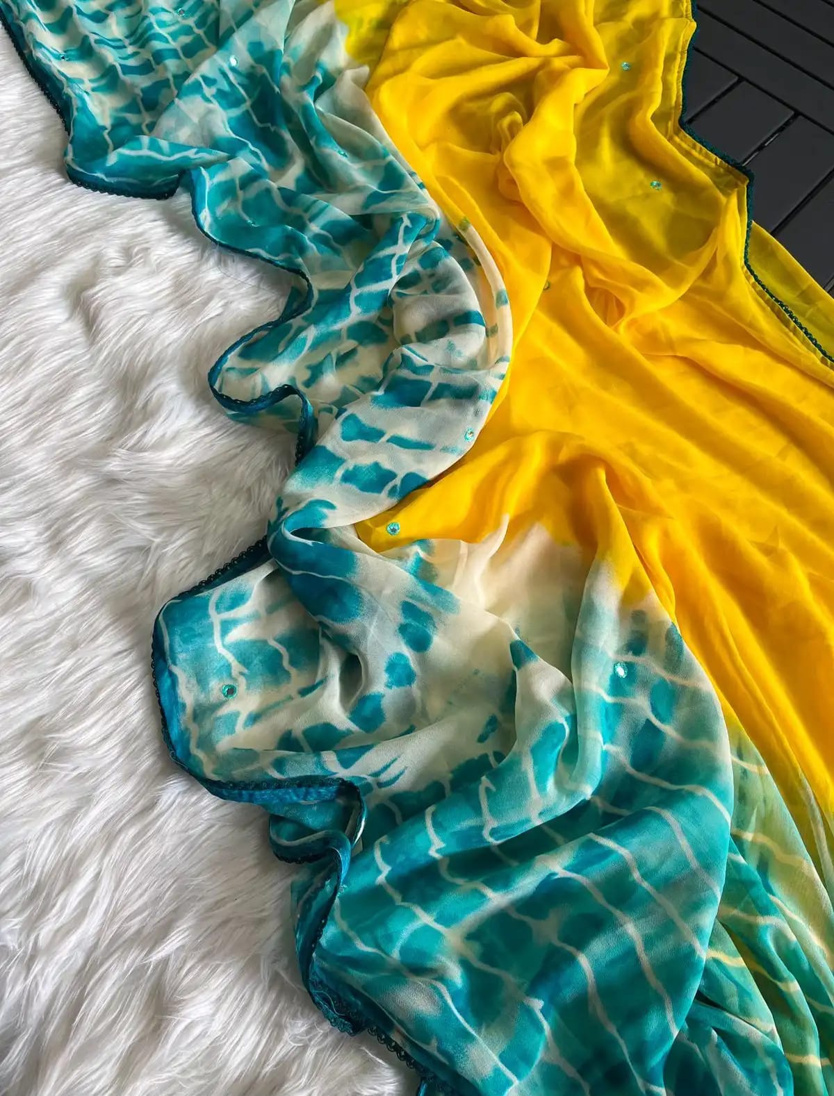 Premium Georgette fabric featuring a beautiful Shibori print and delicate small mirror work.GS080